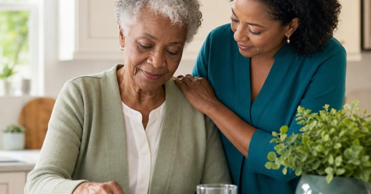 An older adult organizing a weekly pill box with help from a family caregiver